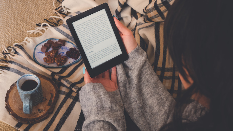 Woman reading a Kindle