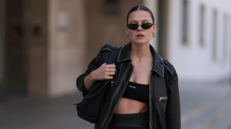 Model wearing bra top with leather jacket