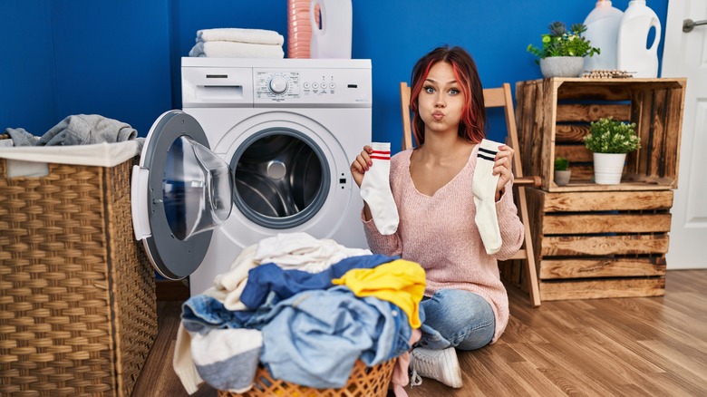 person with mismatched sock laundry