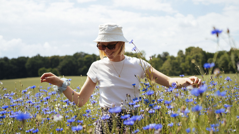 woman wearing bucket hat in field of wildflowers