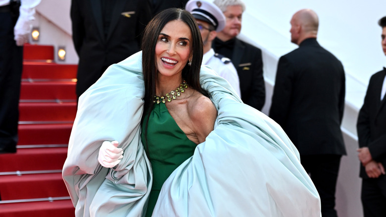 Demi Moore at the Cannes Film Festival wearing a green halter dress with billowy sleeves.