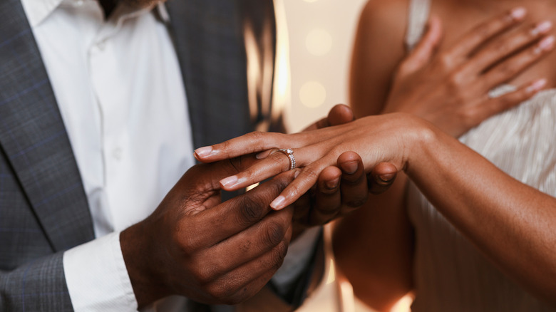 couple holding engagement ring