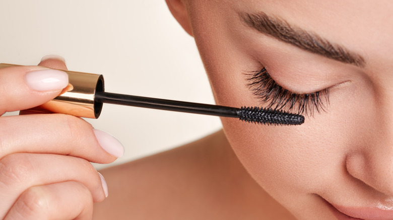 woman applying mascara