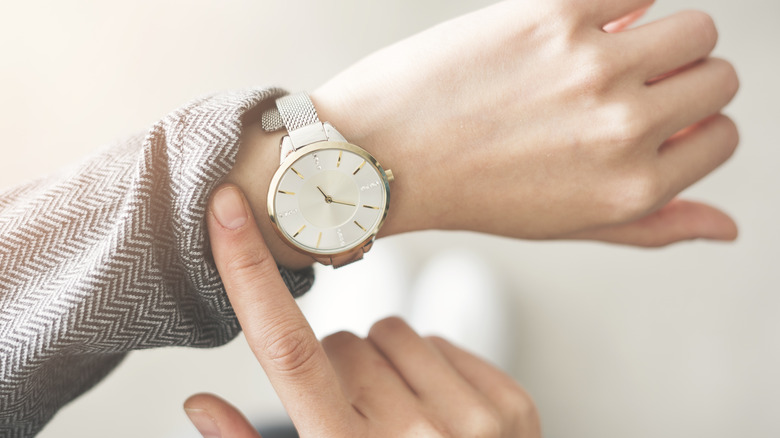 woman checking time on her watch