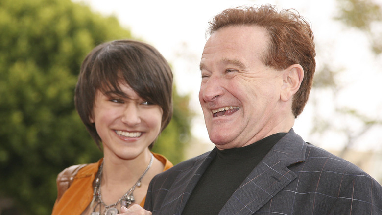 Robin Williams laughing while his daughter Zelda Williams looks at him at the premiere of Columbia Picture's "RV"