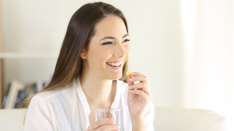 Woman holding a supplement