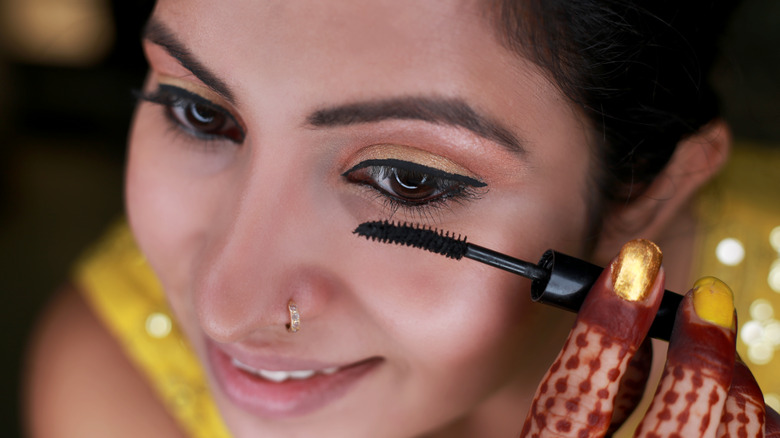 woman applying mascara