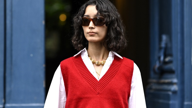 Woman wearing red sweater vest