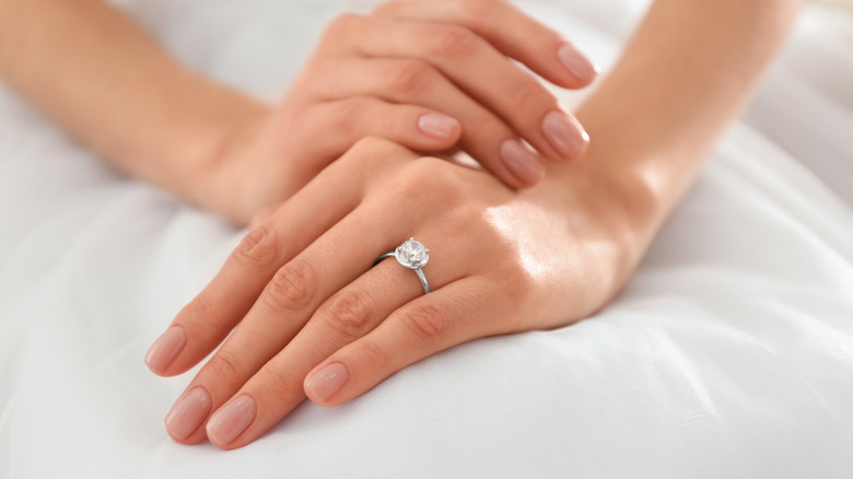 A close-up of a luxurious wedding ring with red ornamental roses, jewelry  and gold making, red roses, an engagement ring, ornaments and accessories,  a ring made of gold - Photo #87410 -