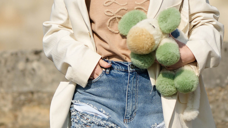 Model tucking hand into jean pocket
