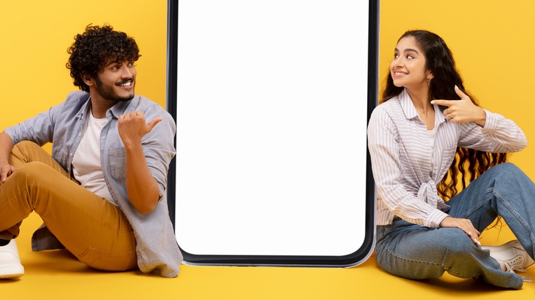 Couple sitting around a phone