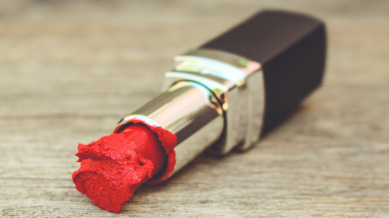 Broken tube of red lipstick