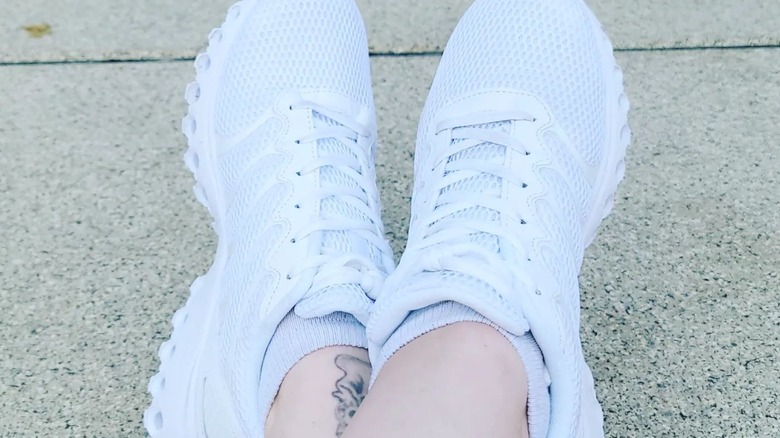 Person wearing white canvas sneakers