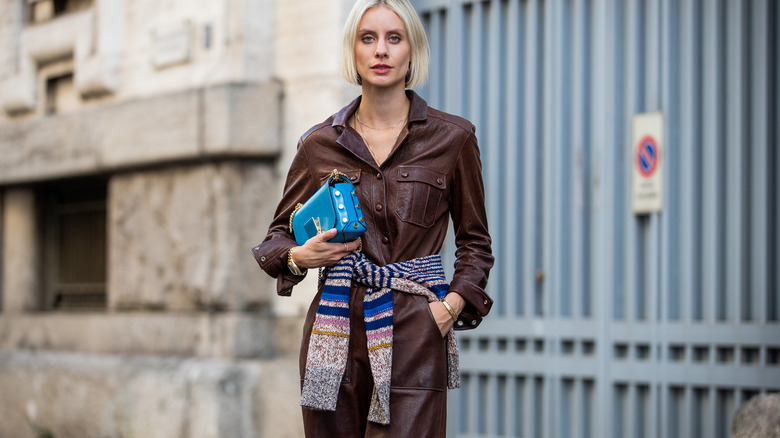 Woman with tied sweater over coat