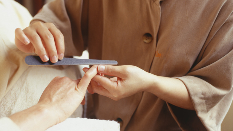 manicurist working on nails