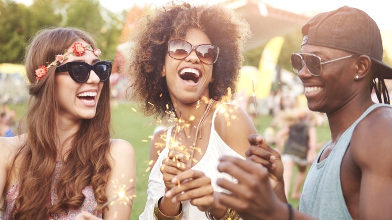 Friends laughing at summer music festival