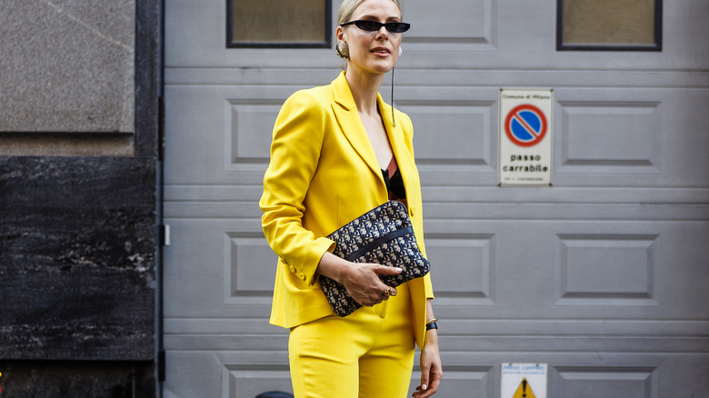 Woman wearing a yellow suit.