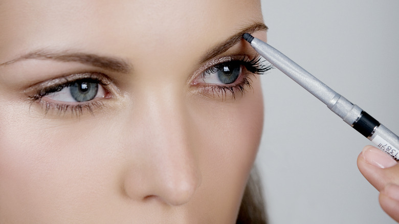 woman with a brow pencil