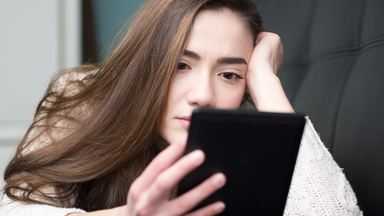 woman reading Kindle