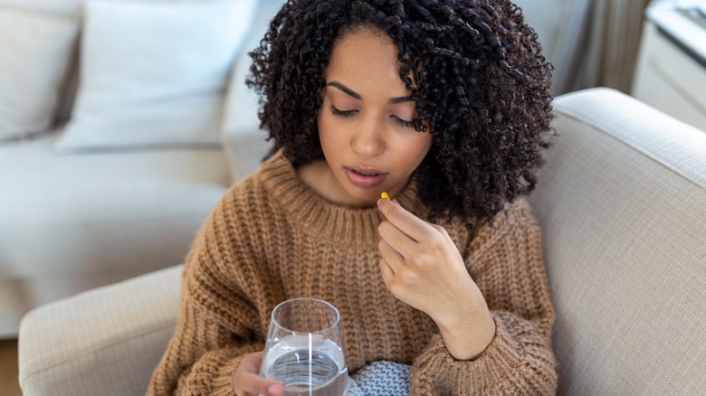 Woman contemplates taking pill