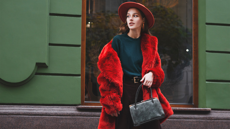 Woman clutching top-handle bag