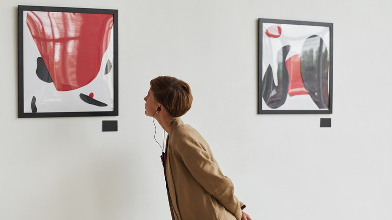 Woman looking at gallery painting