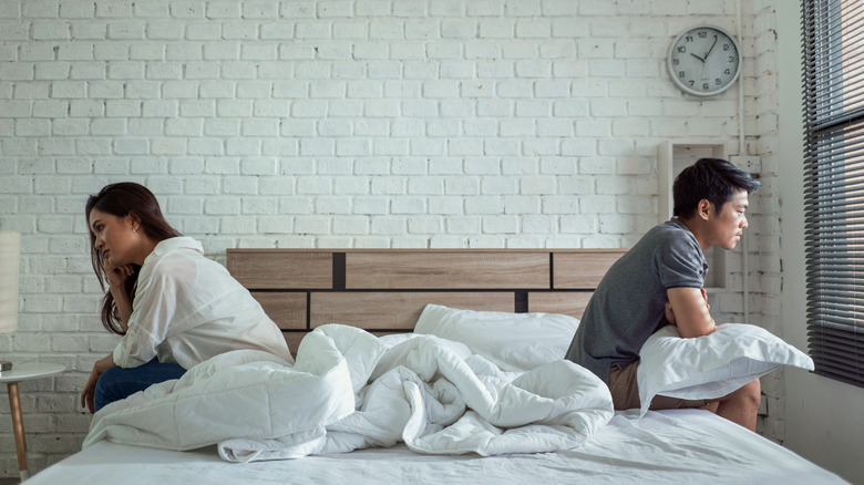 couple fighting in bed 