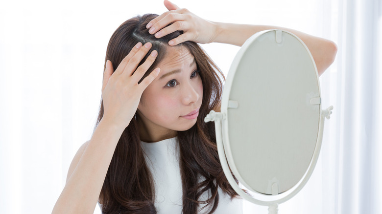 Woman looking at her scalp