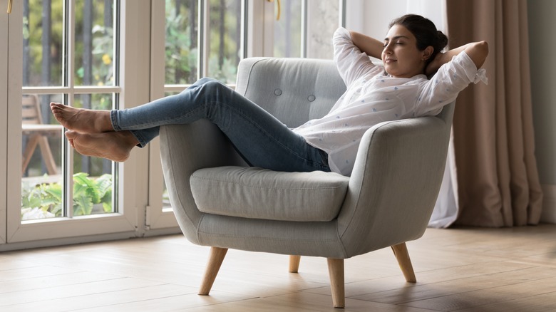 Women enjoying alone time resting on chair