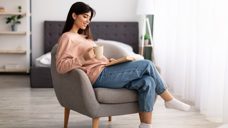 Happy woman reading alone