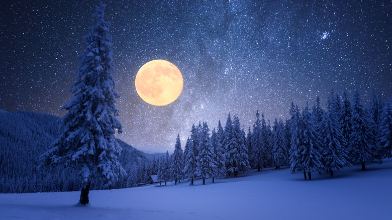 full moon over snowy landscape