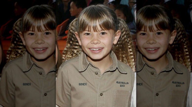 Bindi Irwin smiles in a khaki shirt