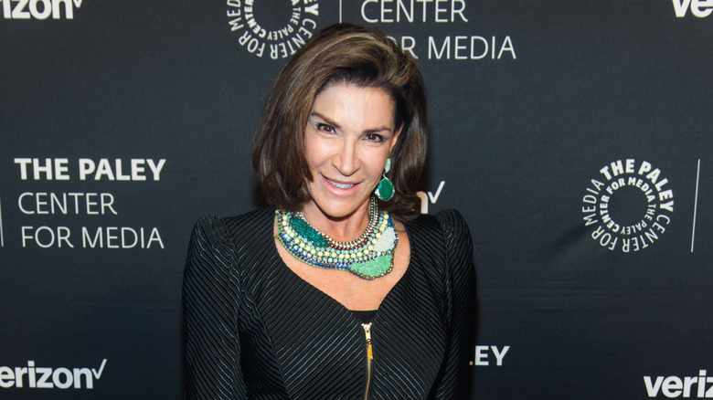 Hilary Farr posing for photos in a black jacket
