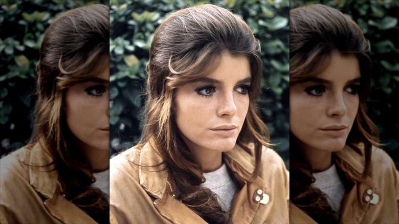 Katharine Ross wearing dark eyemakeup and a half-up, half-down hairdo.