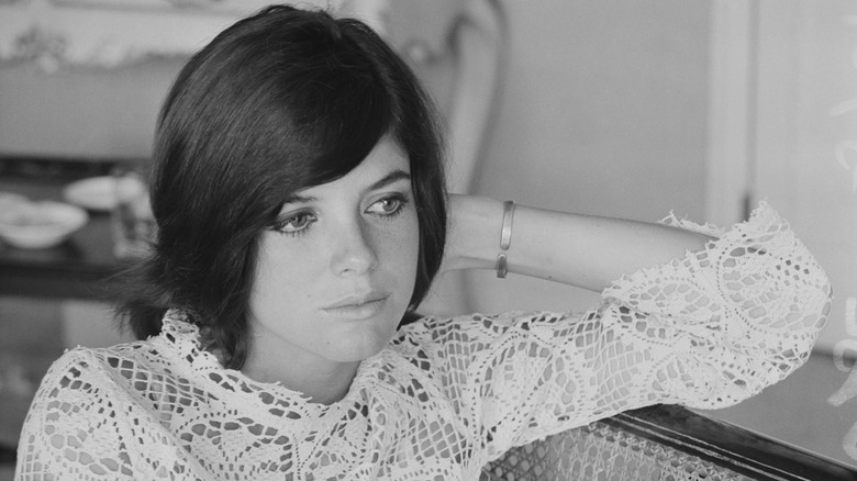Katharine Ross poses with a sweeping side fringe wearing a lace top.