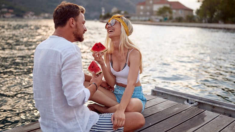 couple eating watermelon on date