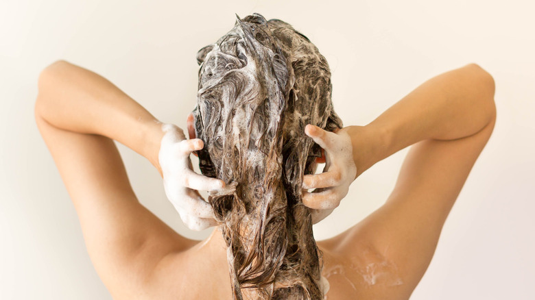 woman shampooing her hair