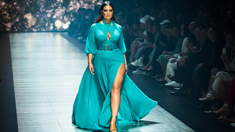 Woman walking runway in teal dress