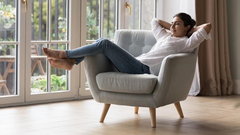 Content woman lounges in chair