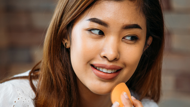 Woman applying foundation 