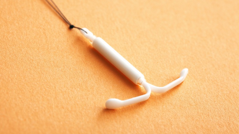 IUD on orange background