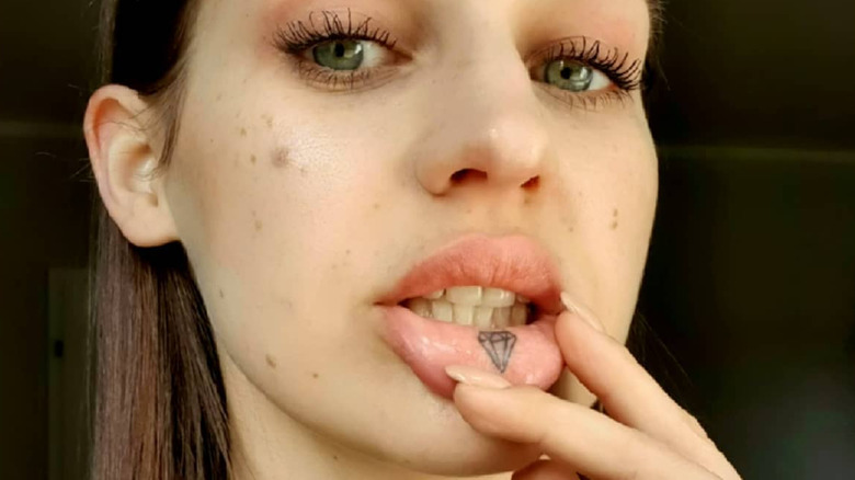 person with an inner lip tattoo