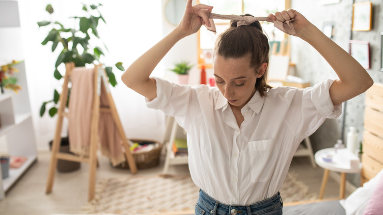 Woman tightening her ponytail