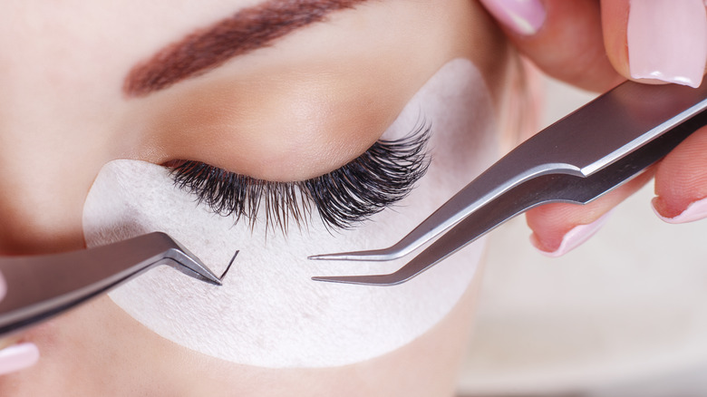 Eyelash extensions being installed