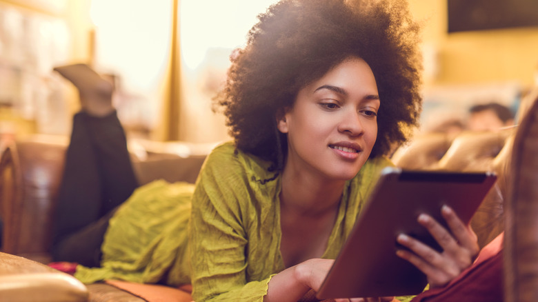 African American Woman reading on her kindle