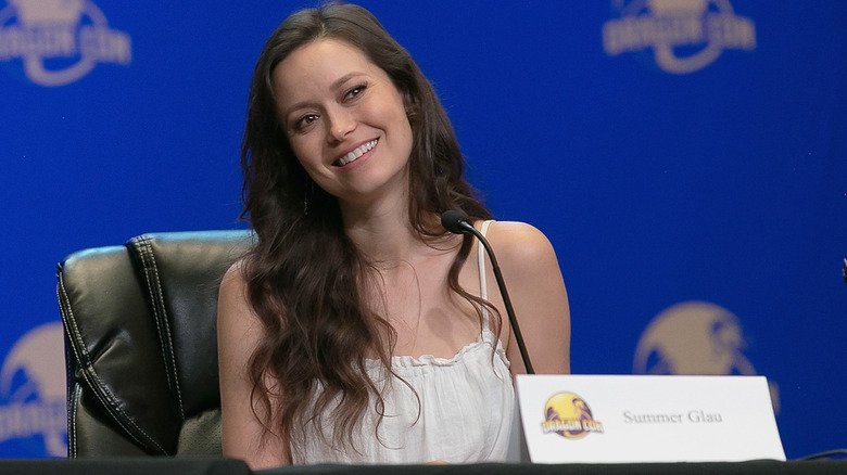 Summer Glau smiles while sitting on a panel at a fan convention