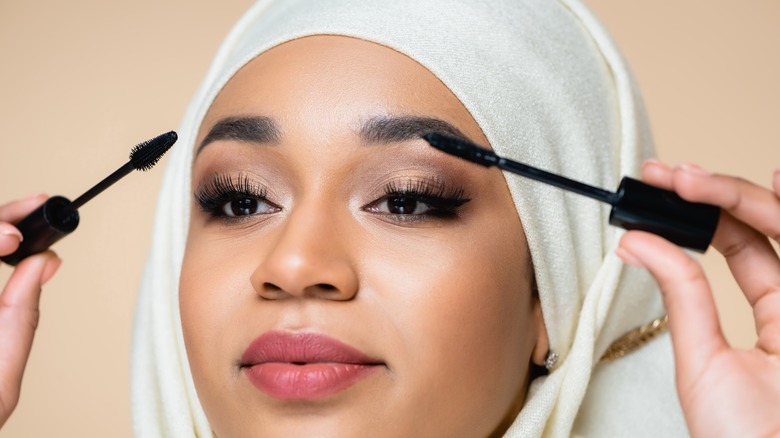 hijabi woman applying mascara