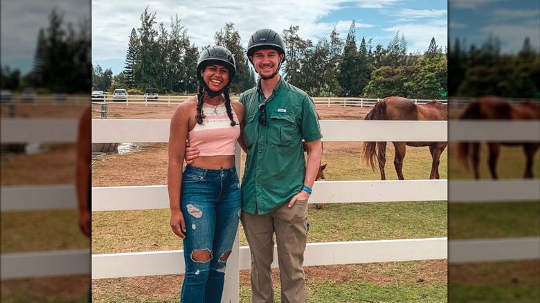 Katelynn Shennett stands beside her husband Jake Stille on a horse ranch