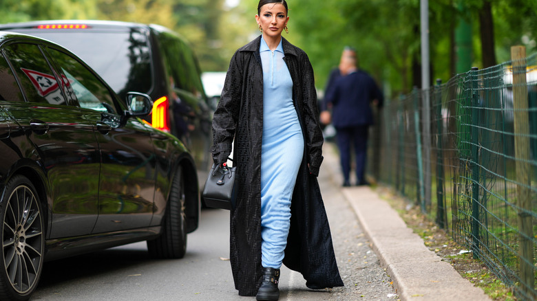 woman in floor-length trenchcoat