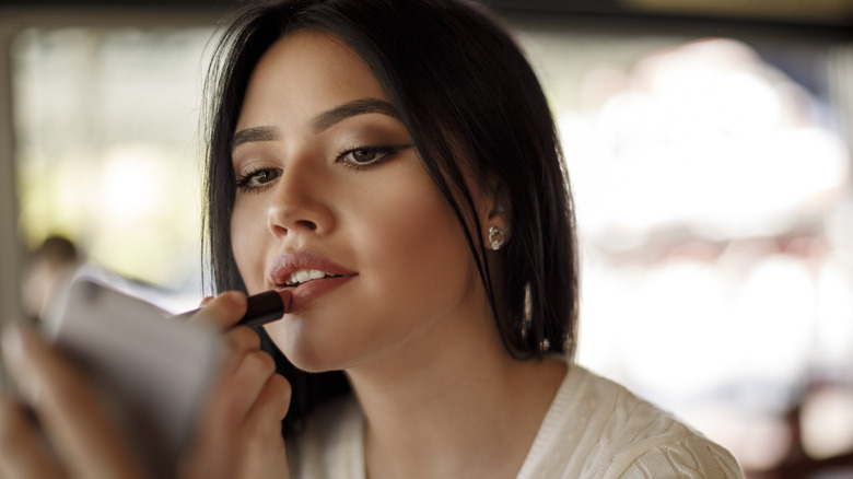 woman applying lip stain 